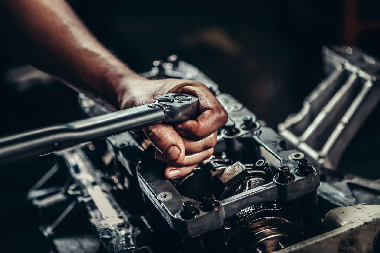 Mechanic working on car diesel engine